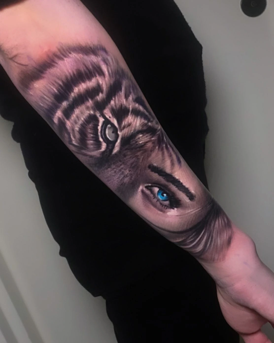 Tiger face merging with woman's blue eye