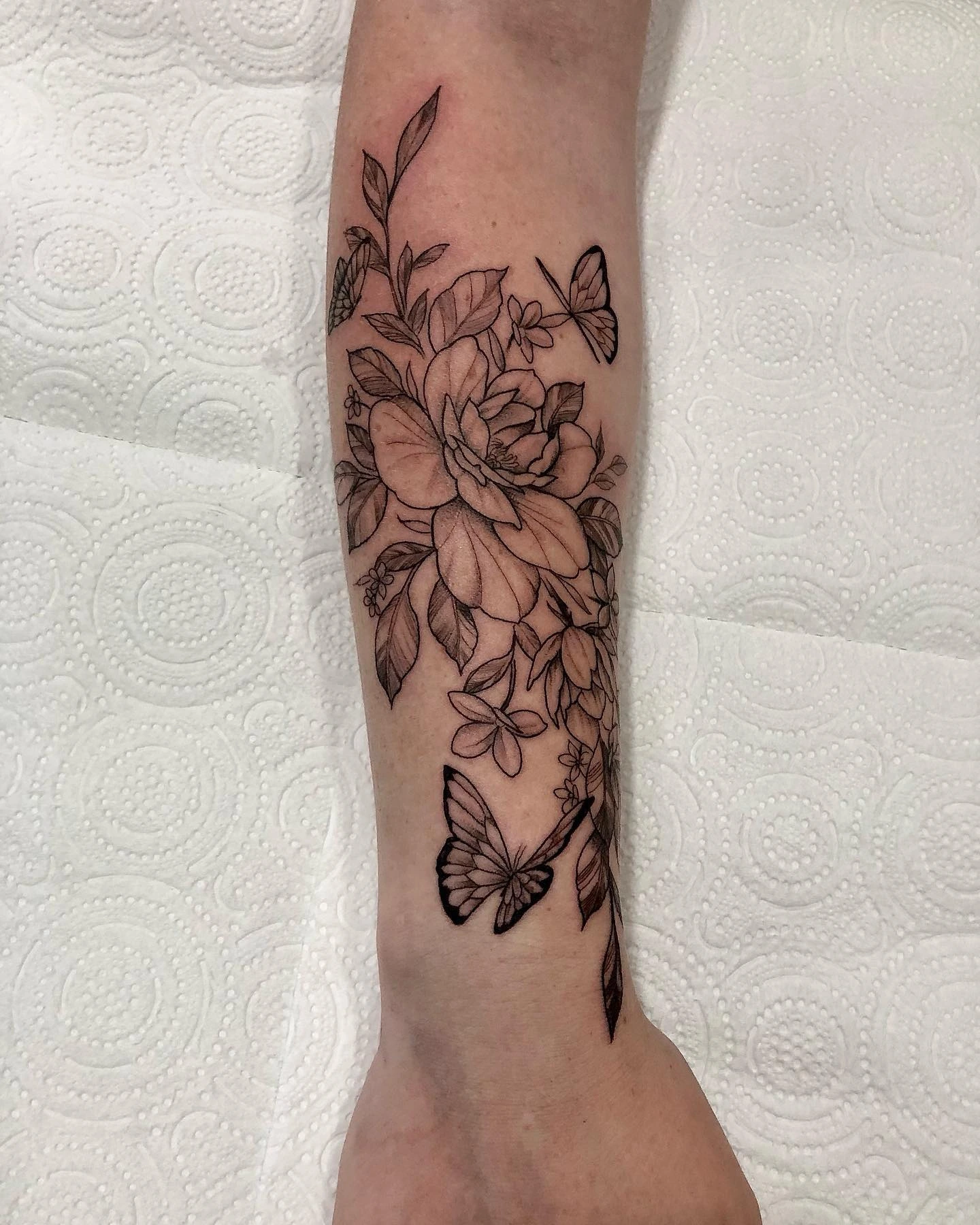 Floral with butterflies cascading down forearm