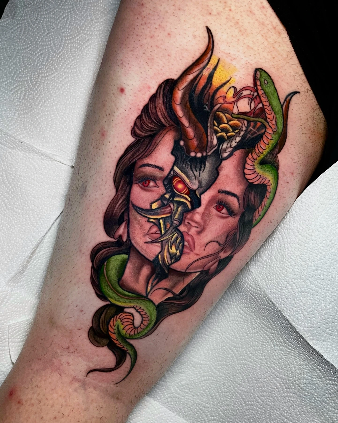 Demon-headed woman with horns and snake — siamese-twin style