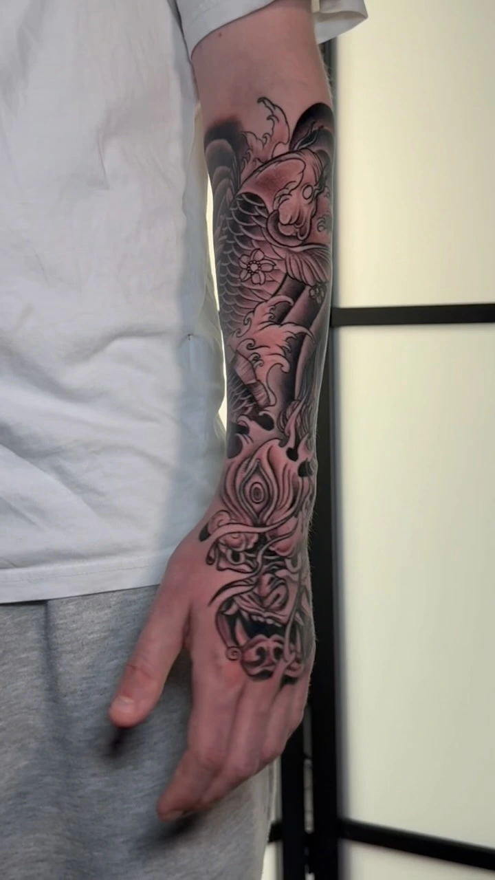 Japanese half sleeve in progress: hannya, lotus, waves, dragon