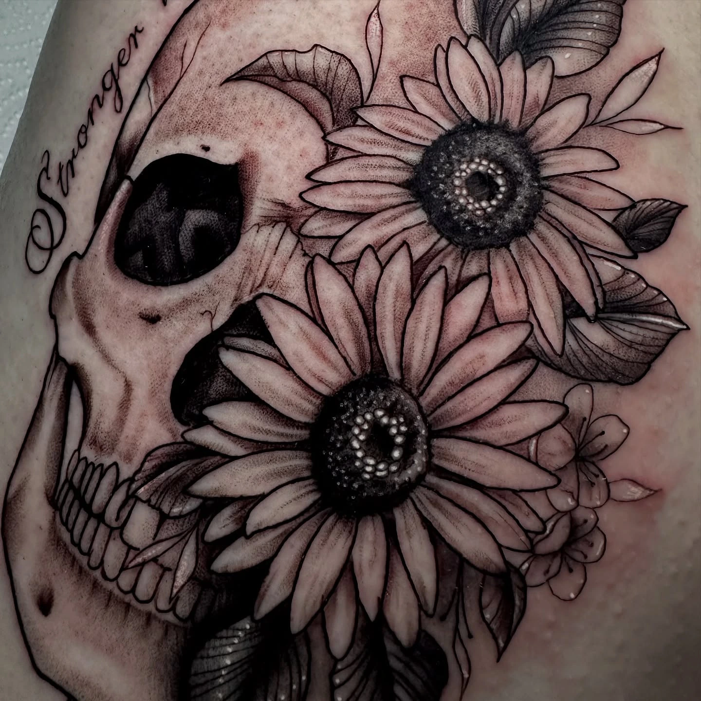 Skull with sunflowers and 'Stronger than death' script