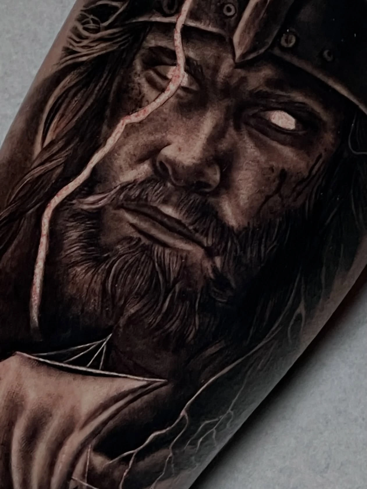 Viking warrior close-up with helmet and beard, white-eye effect