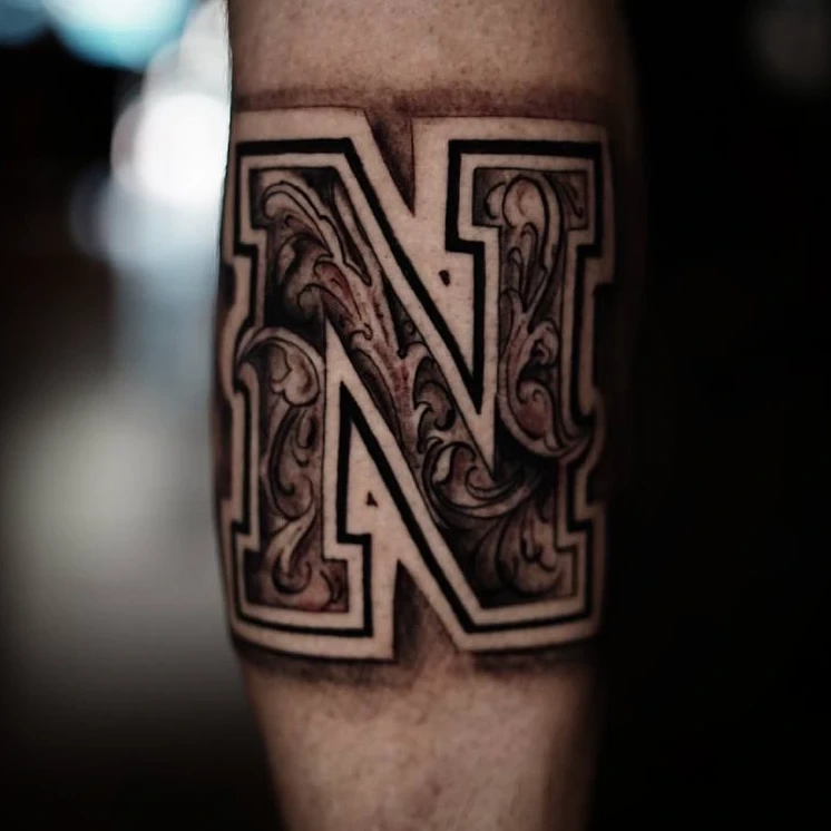 Block letter 'N' monogram with engraved filigree fill