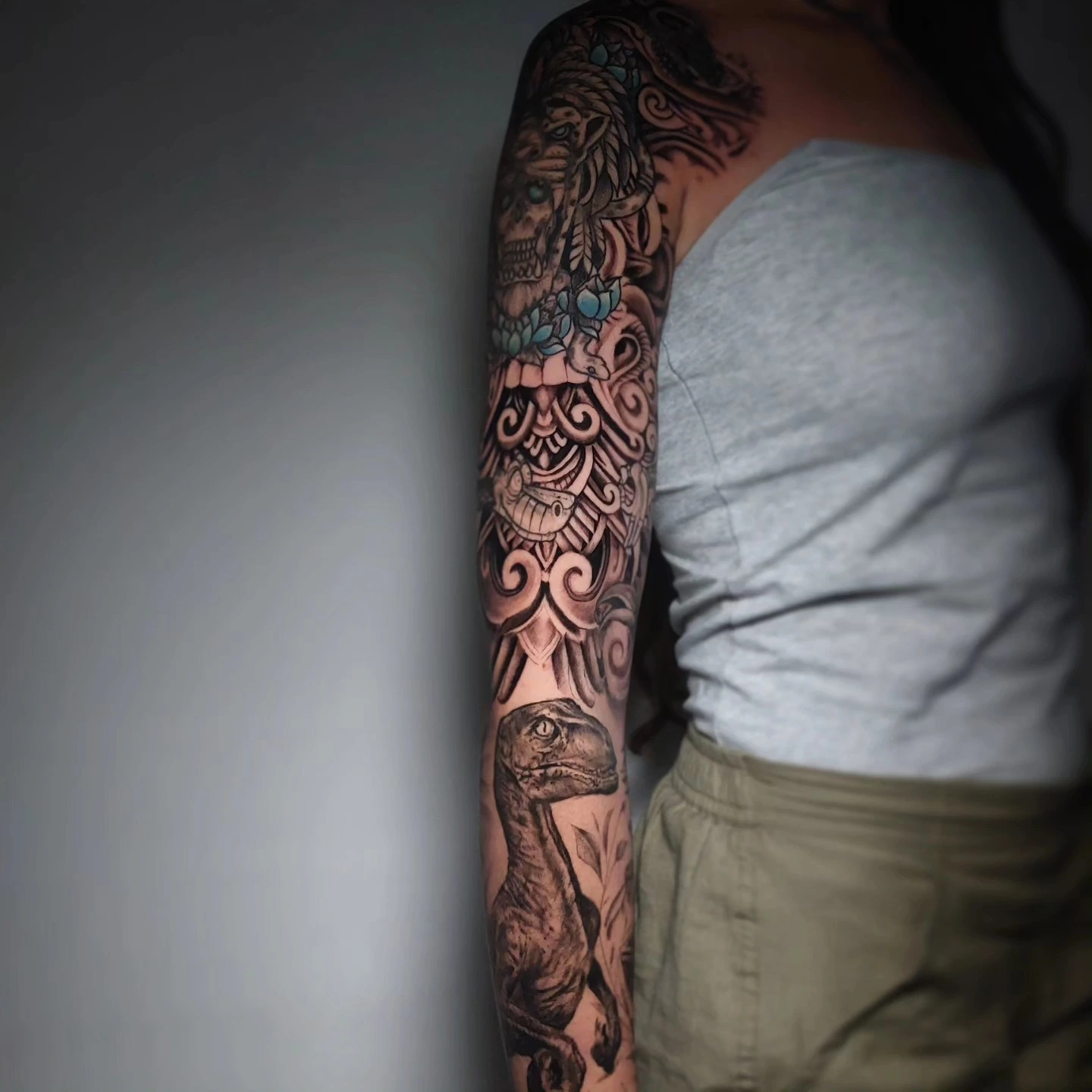 Aztec/Mayan headdress sleeve top with velociraptor at base