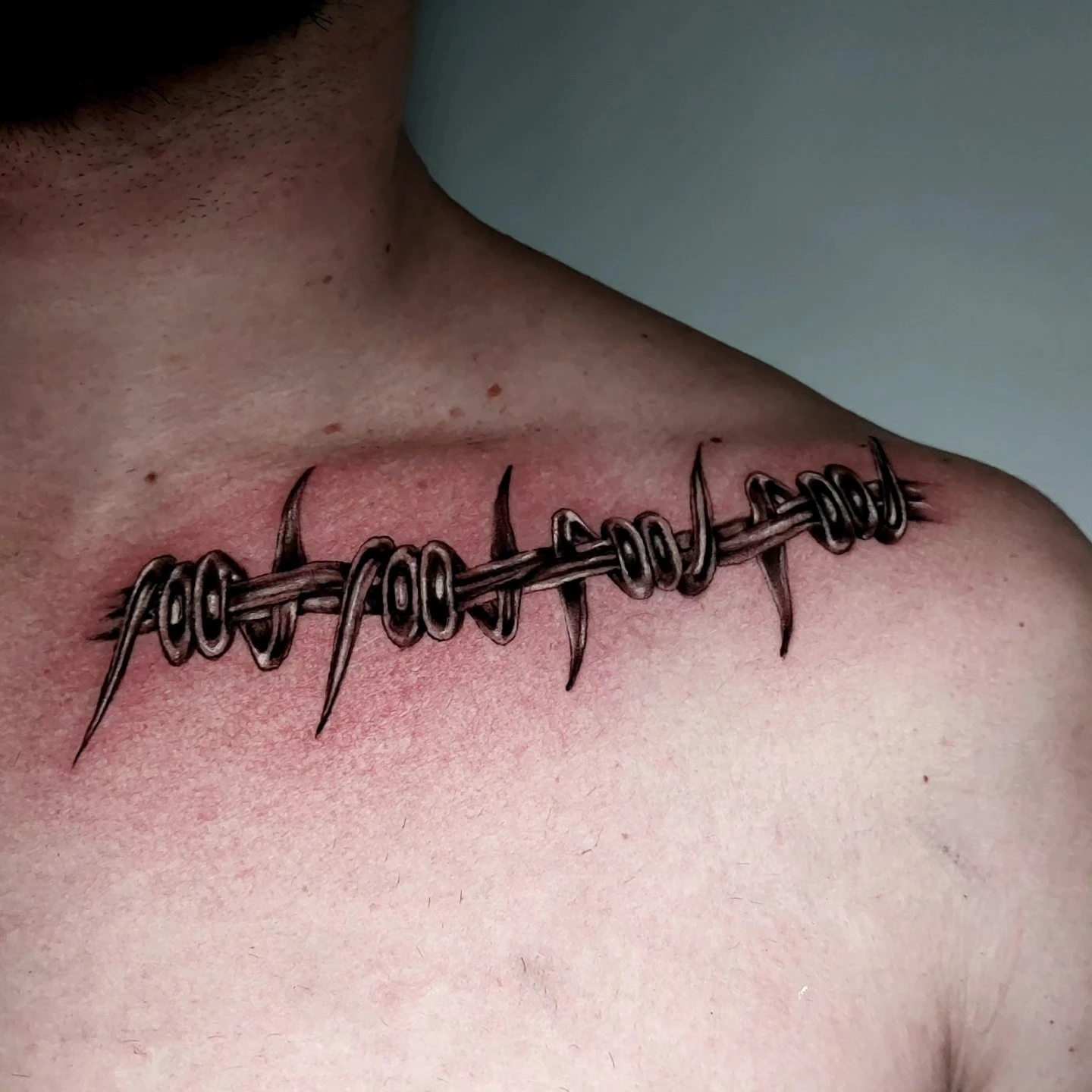Single Old English filigree letter 'I' (or 'J') behind ear