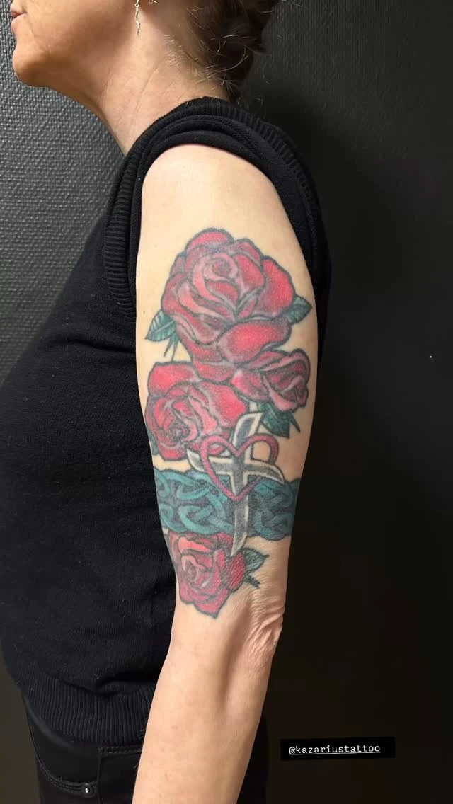 Saturated red roses with cross-and-heart center, traditional flash style