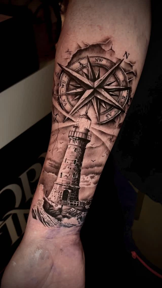 compass-and-lighthouse forearm sleeve, cracked-stone background