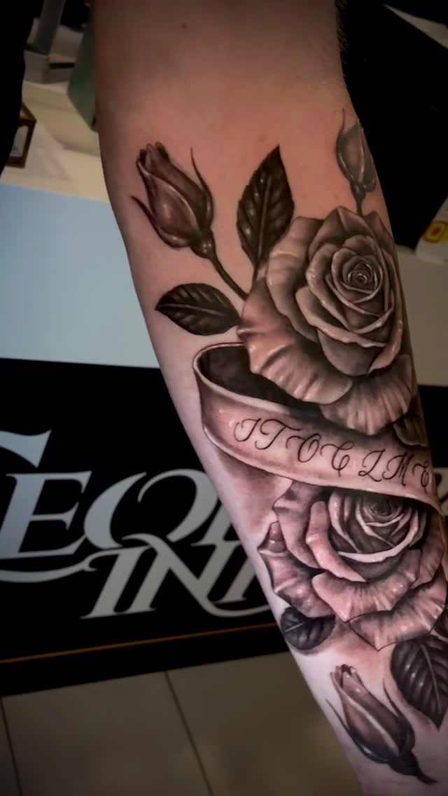 two photoreal black-and-grey roses with banner lettering